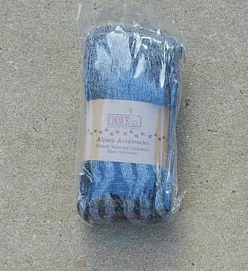 A pair of stylish thick cabled alpaca leg warmers in a cozy setting, showcasing their soft texture and fashionable design.