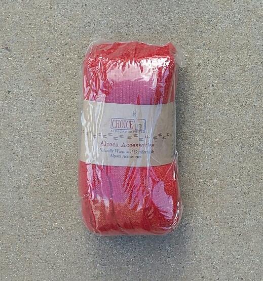 A pair of stylish thick cabled alpaca leg warmers in a cozy setting, showcasing their soft texture and fashionable design.