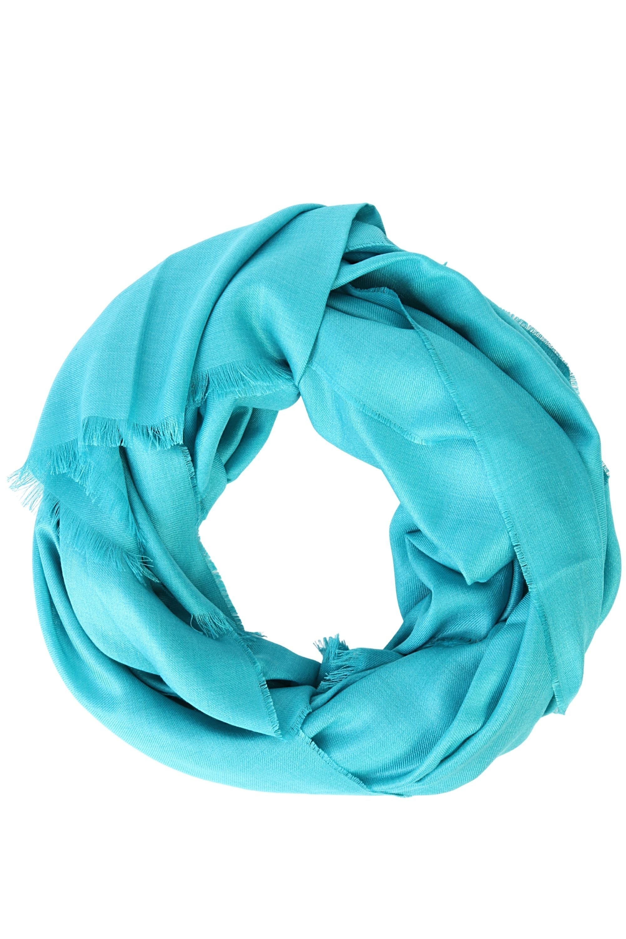 Luxurious turquoise shawl made of 70% royal alpaca and 30% silk, showcasing its soft texture and elegant drape.