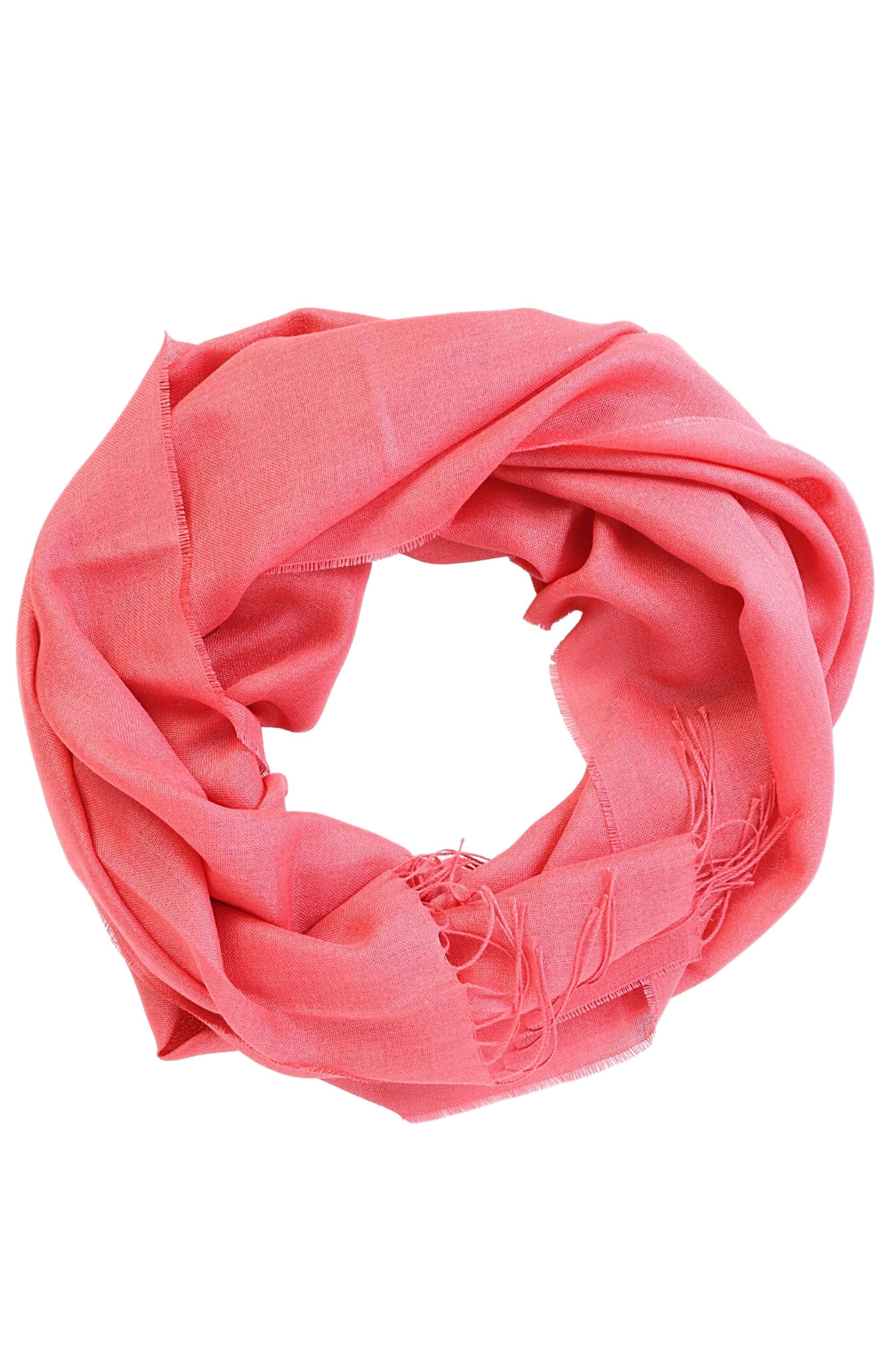 Coral-pink alpaca wool and silk shawl draped elegantly, showcasing its luxurious texture and color.