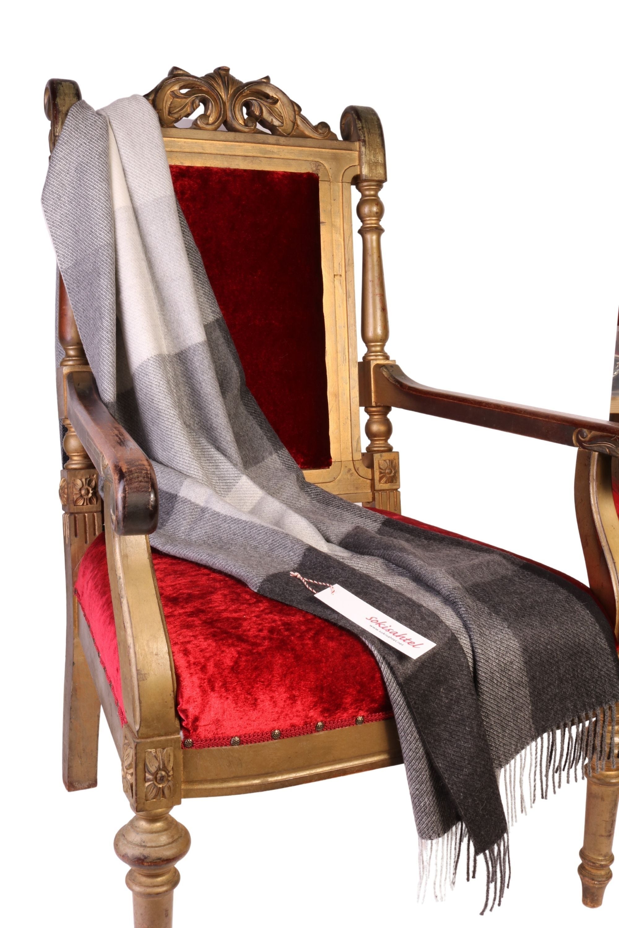 Luxurious black-gray checked small plaid throw made from 100% alpaca wool, showcasing its soft texture and elegant design.