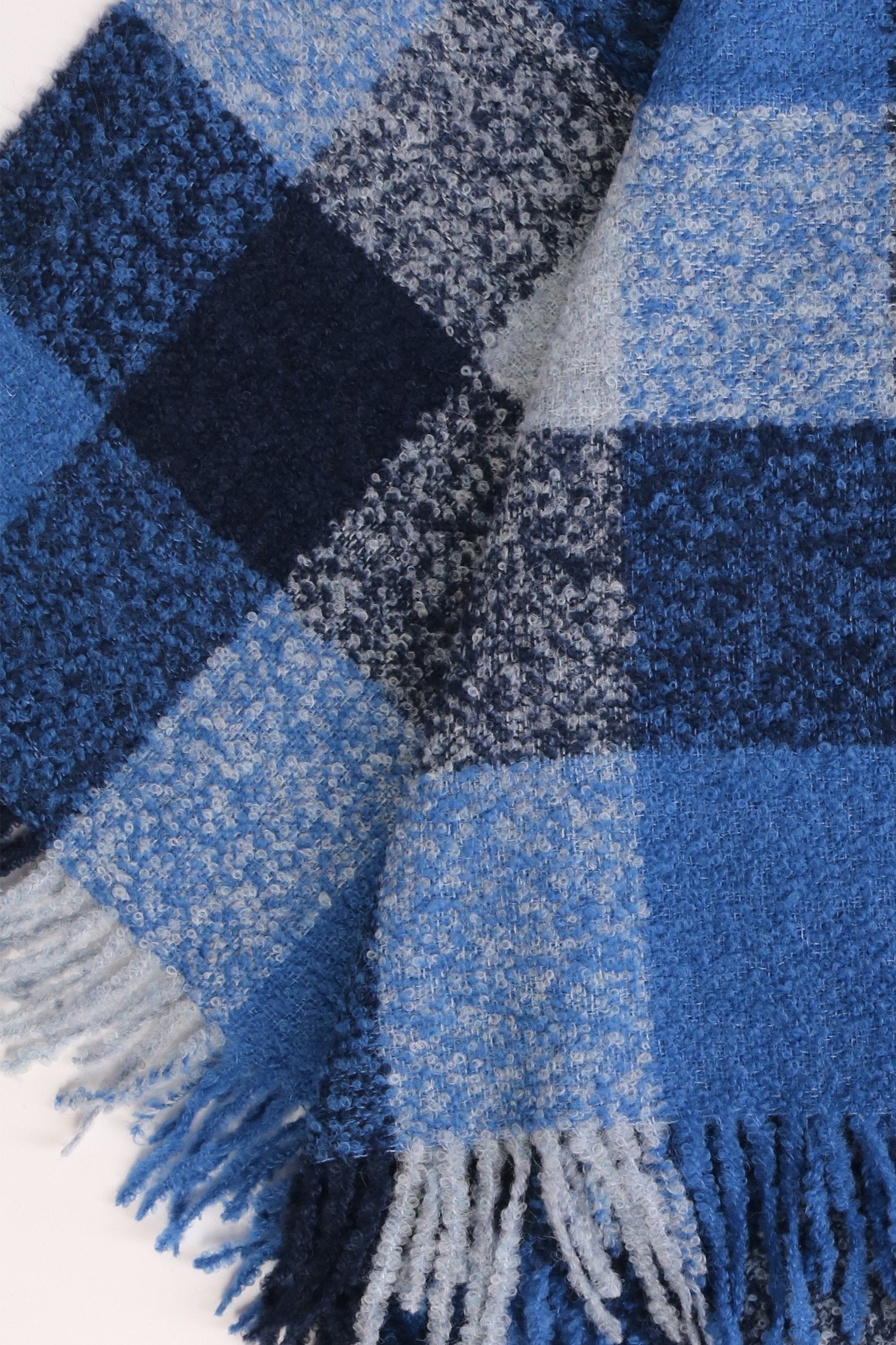 Luxurious blue grey checkered plaid made from 100% alpaca wool, showcasing its elegant design and soft texture.