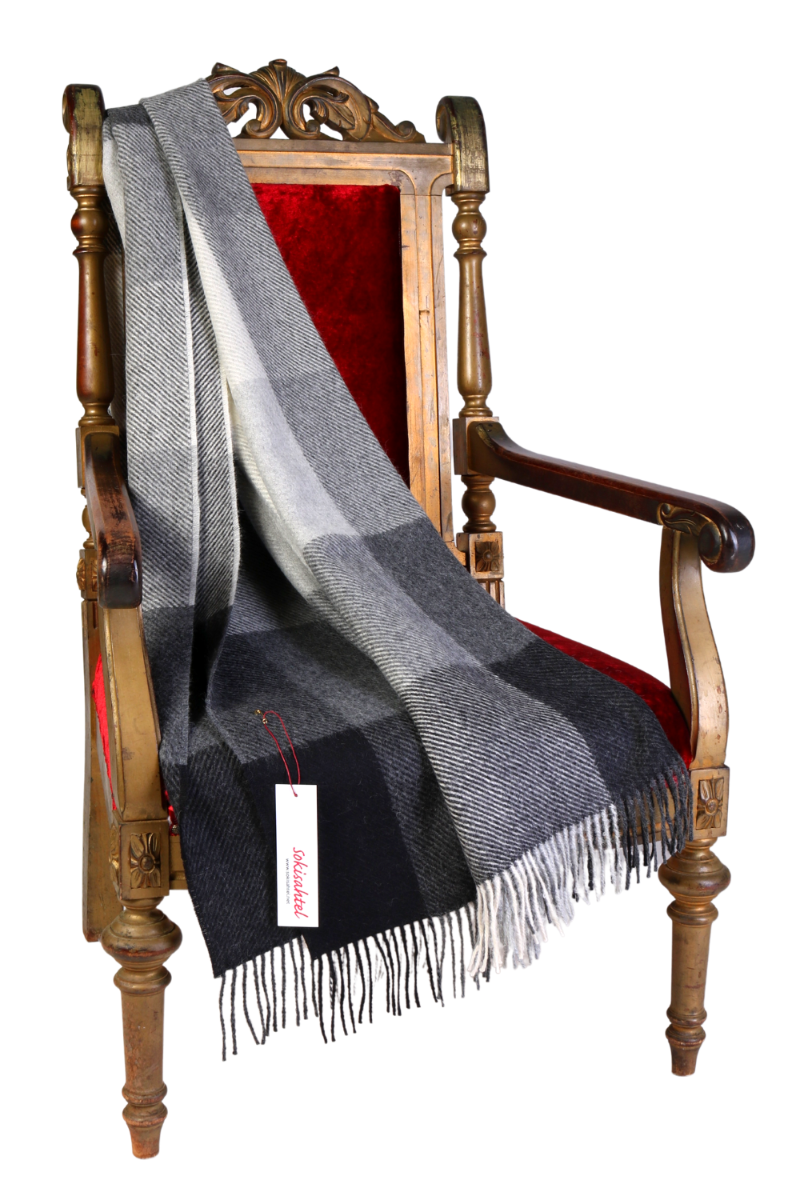 Luxurious grey and black chequered alpaca wool plaid blanket, showcasing its soft texture and elegant design.