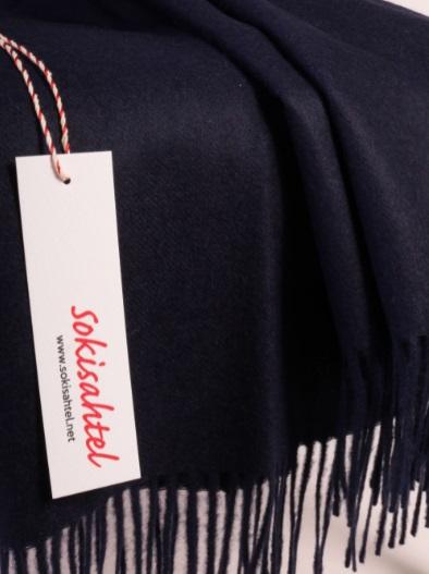 Luxurious dark blue plaid made from 100% alpaca wool, showcasing its soft texture and elegant design.