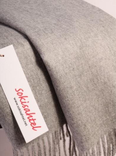 Luxurious grey plaid made from 100% baby alpaca wool, showcasing its soft texture and elegant design.