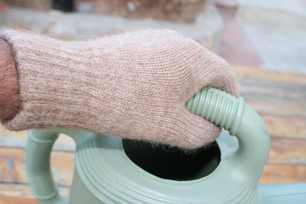A pair of warm and durable Alpaca Work/Play Gloves in natural colors, showcasing their soft texture and unisex design.