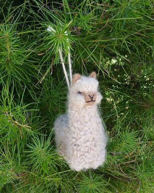 A collection of adorable hand made baby alpaca ornaments in various colors and sizes, showcasing their unique craftsmanship and charm.