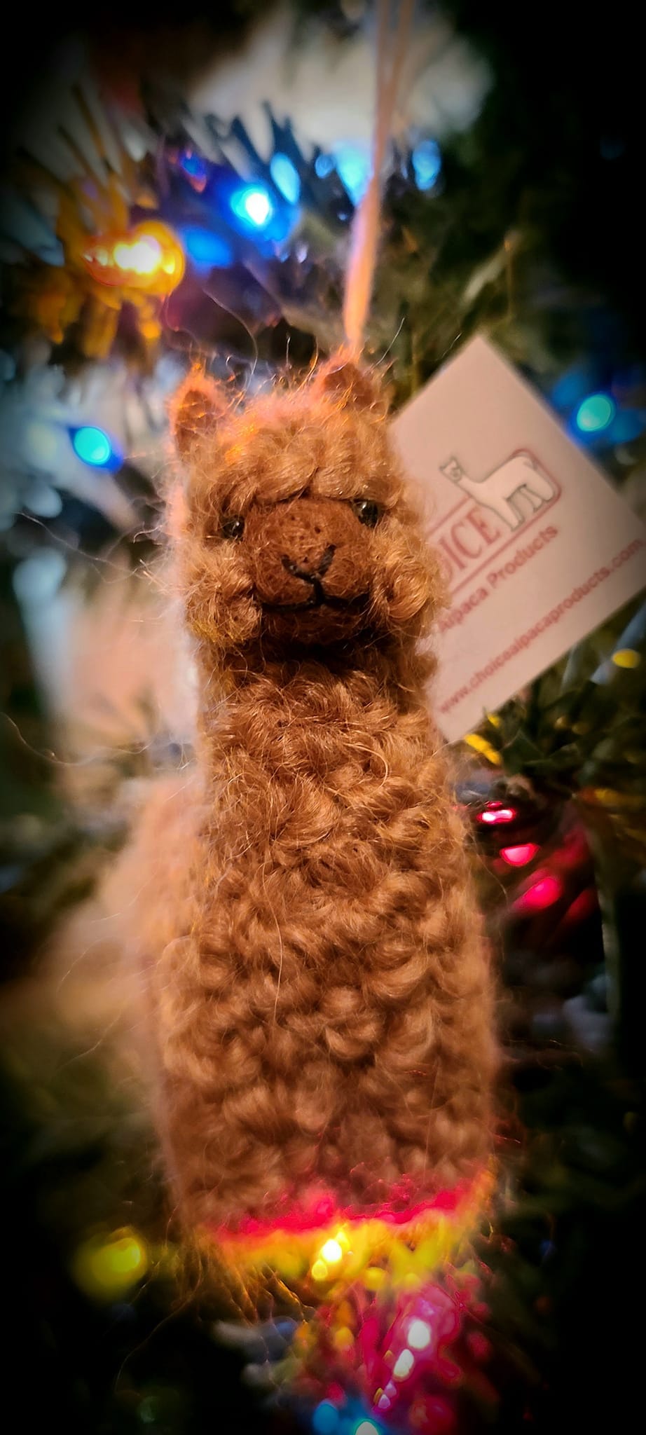 A collection of adorable hand made baby alpaca ornaments, showcasing their unique designs and soft textures, perfect for holiday decorations.
