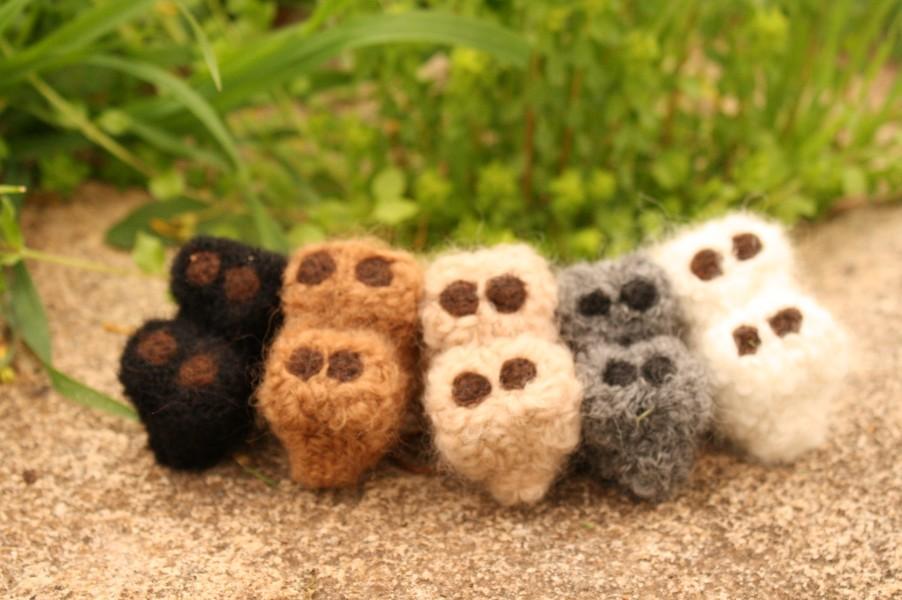 A collection of adorable hand made baby alpaca ornaments, showcasing their unique designs and soft textures, perfect for holiday decorations.