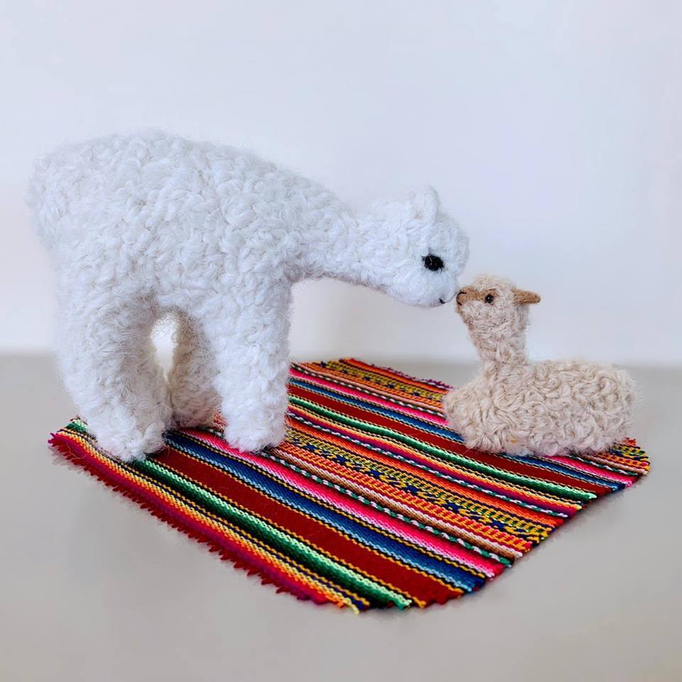 Handmade baby alpaca ornaments featuring a mom and her cria, showcasing intricate details and soft textures.