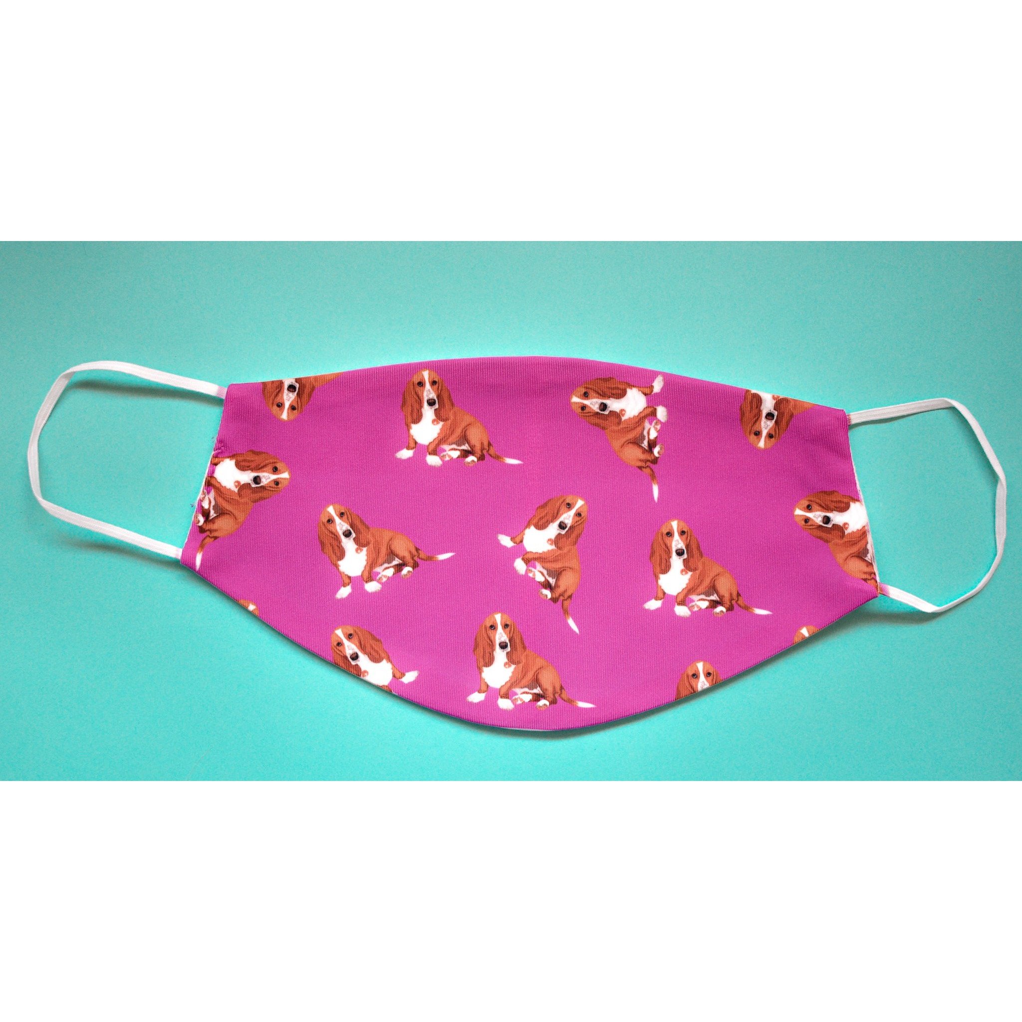 A handmade Basset Hound face cover featuring a cute dog design, made from breathable polyester and organic cotton.