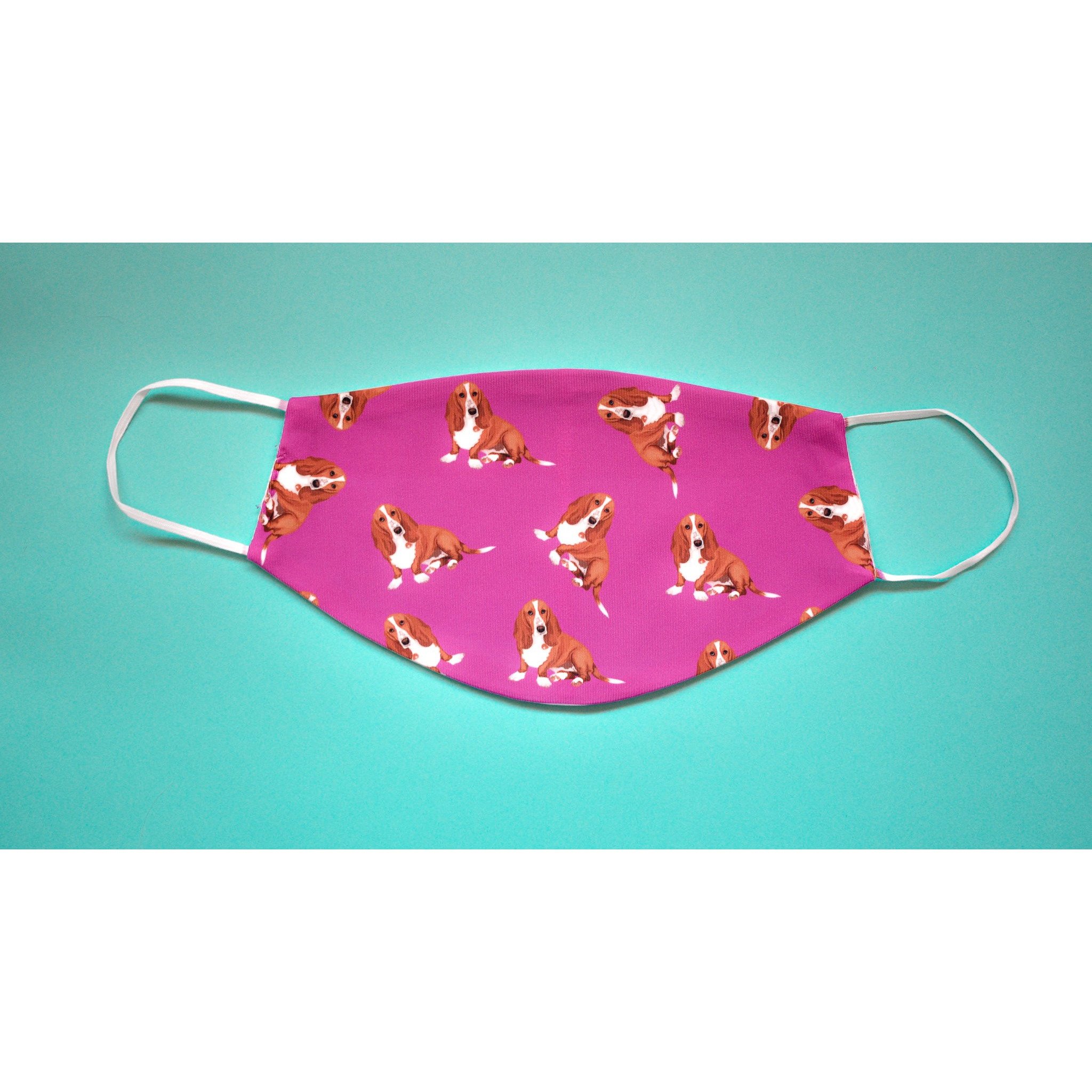 A handmade Basset Hound face cover featuring a cute dog design, made from breathable polyester and organic cotton.