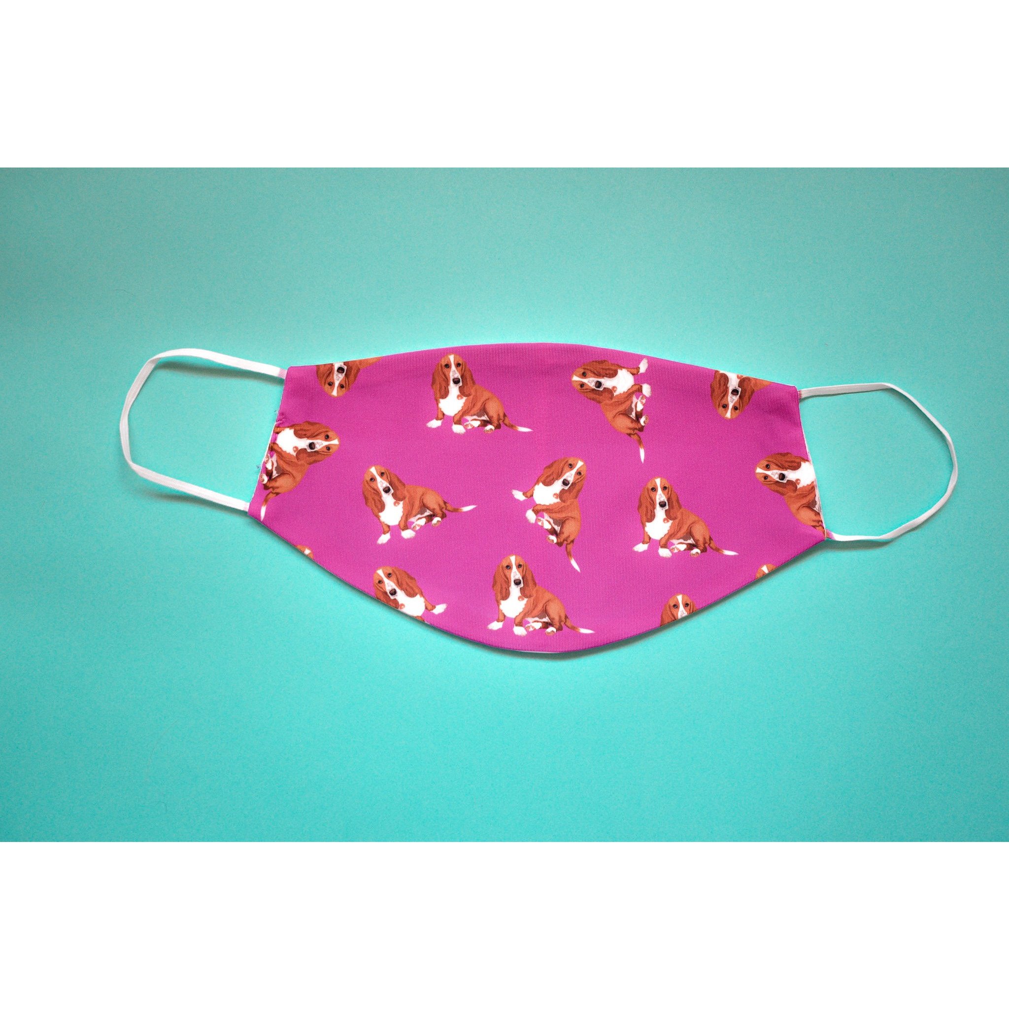 A handmade Basset Hound face cover featuring a cute dog design, made from breathable polyester and organic cotton.