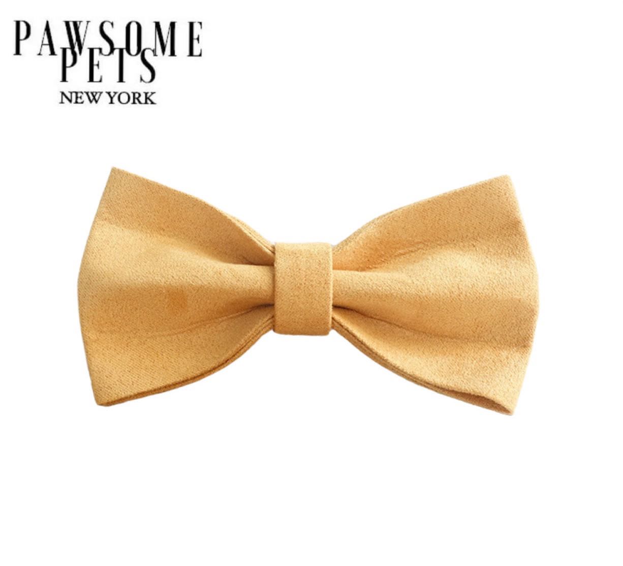 A stylish handmade bow tie in honey color, made from 100% cotton with Velcro straps for easy attachment to pet collars.