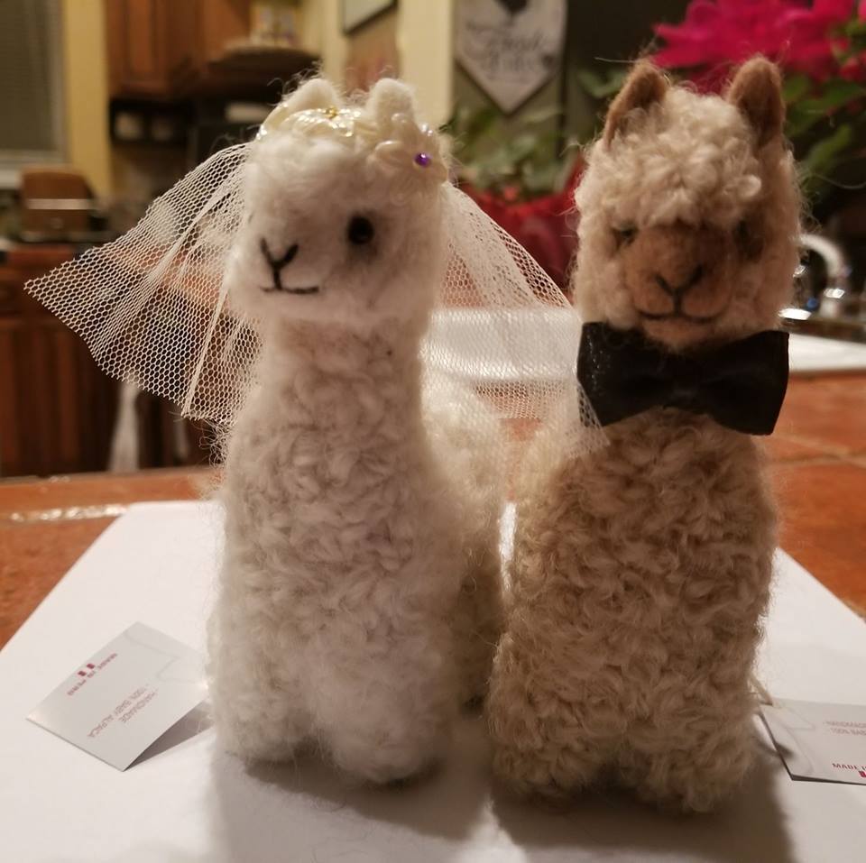 Handmade Bride and Groom Alpacadorable ornaments made from 100% baby alpaca, showcasing intricate details and vibrant colors.