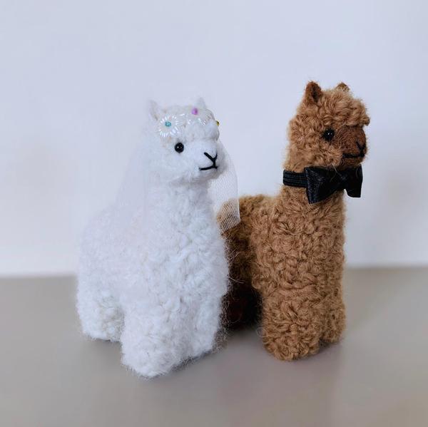 Handmade Bride and Groom Alpacadorable ornaments made from 100% baby alpaca, showcasing intricate details and vibrant colors.