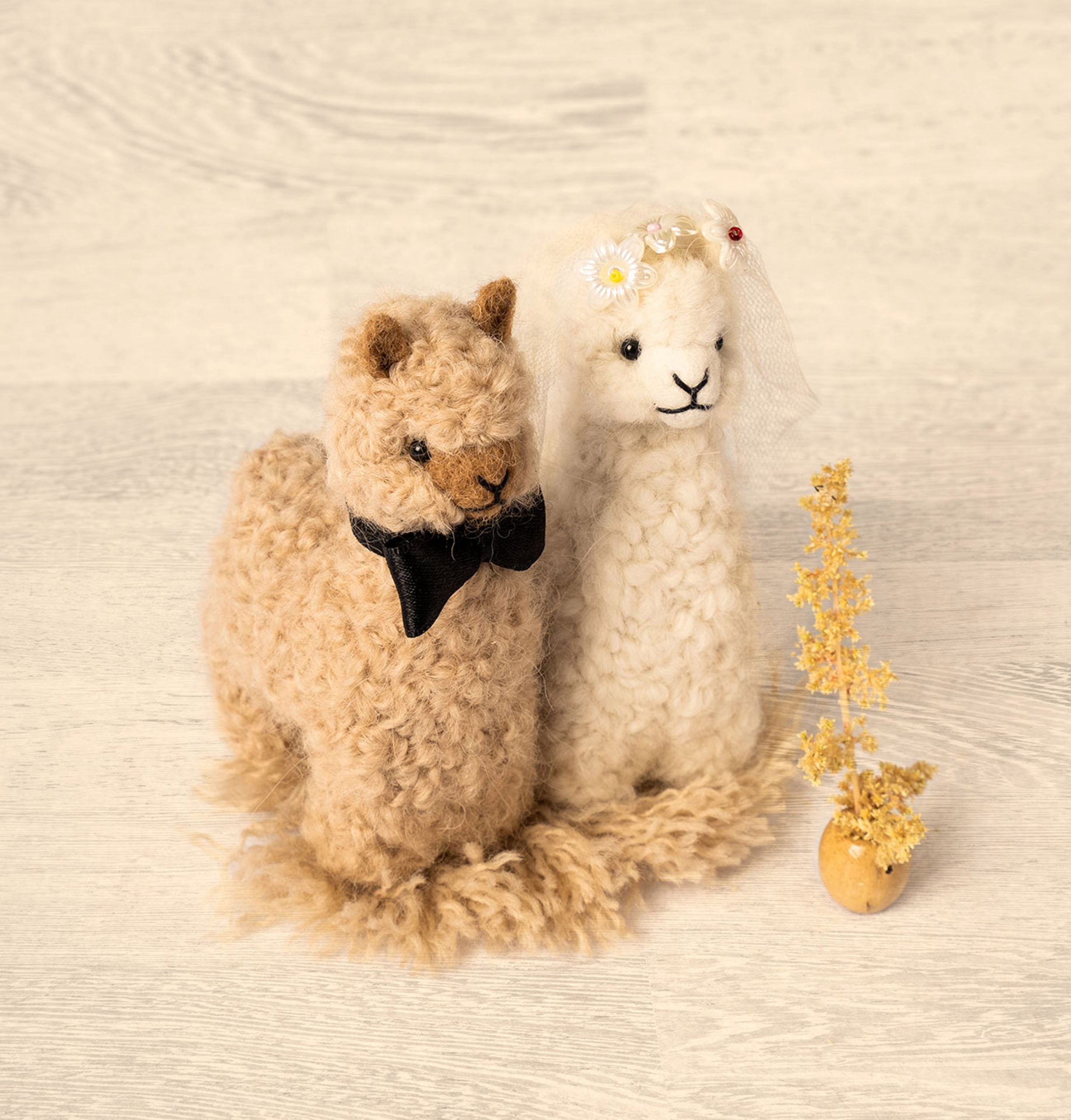 Handmade Bride and Groom Alpacadorable ornaments made from 100% baby alpaca, showcasing intricate details and vibrant colors.