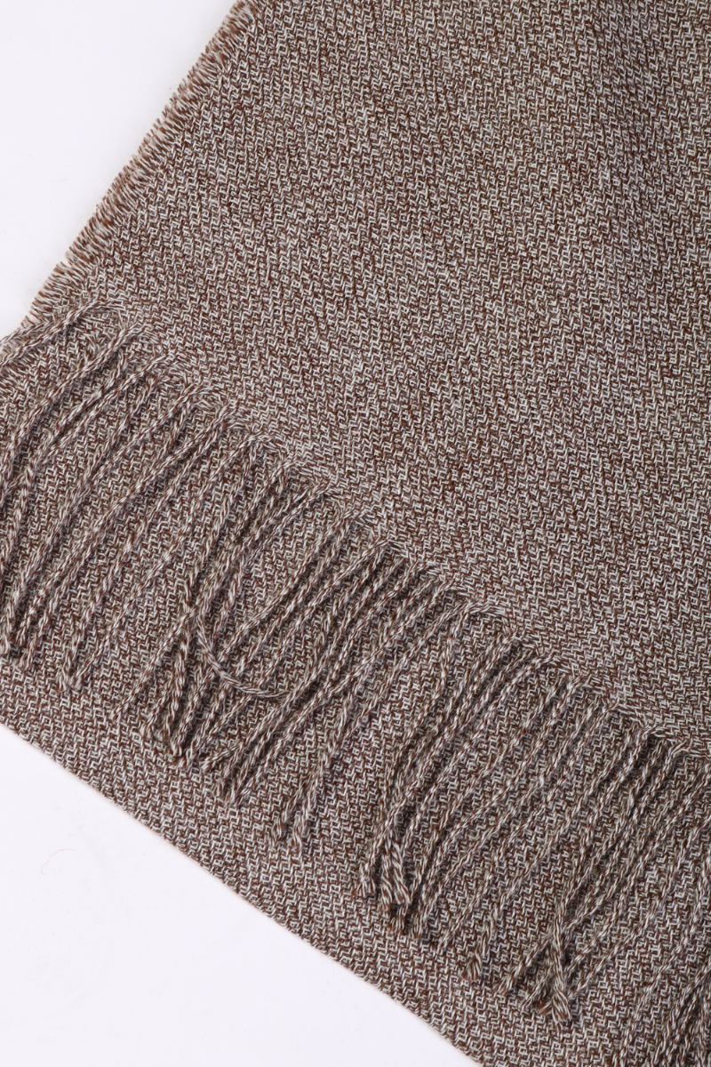A luxurious brown ruffled alpaca wool scarf, showcasing its soft texture and elegant design, perfect for cold evenings.