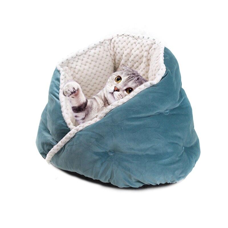 Soft triangular cat bed in warm colors, perfect for pets to snuggle and sleep comfortably.
