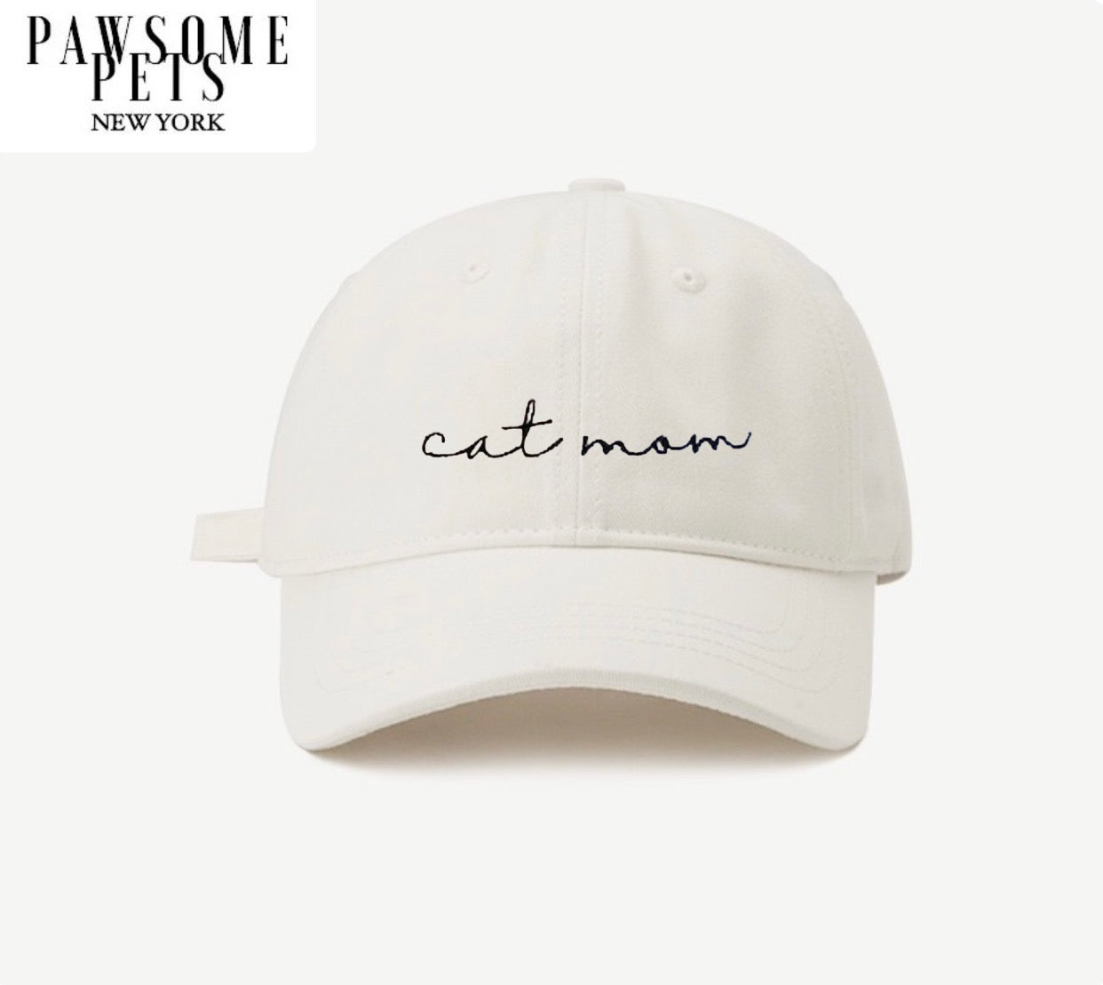 White baseball cap with embroidered CAT MOM lettering, adjustable metal buckle closure, and pre-curved visor.