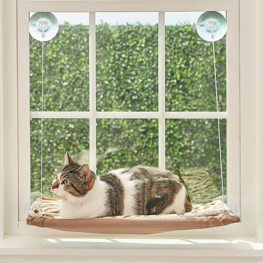 A cozy cat window seat hammock, designed for cats to relax and enjoy sunny views, featuring strong suction cups for secure mounting.
