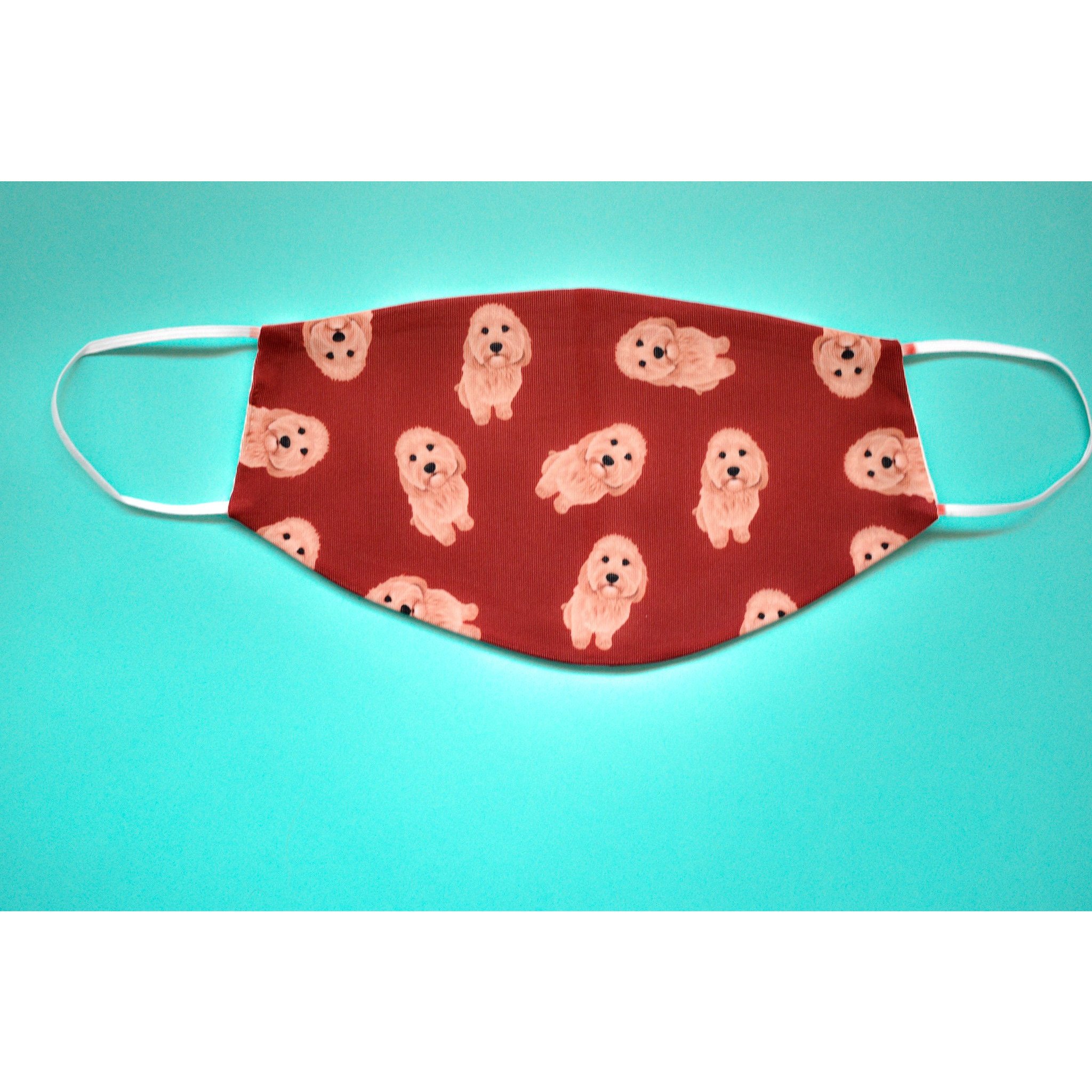 A stylish Cavapoo face cover made from breathable polyester and organic cotton, featuring a comfortable ear saver and available in various sizes.