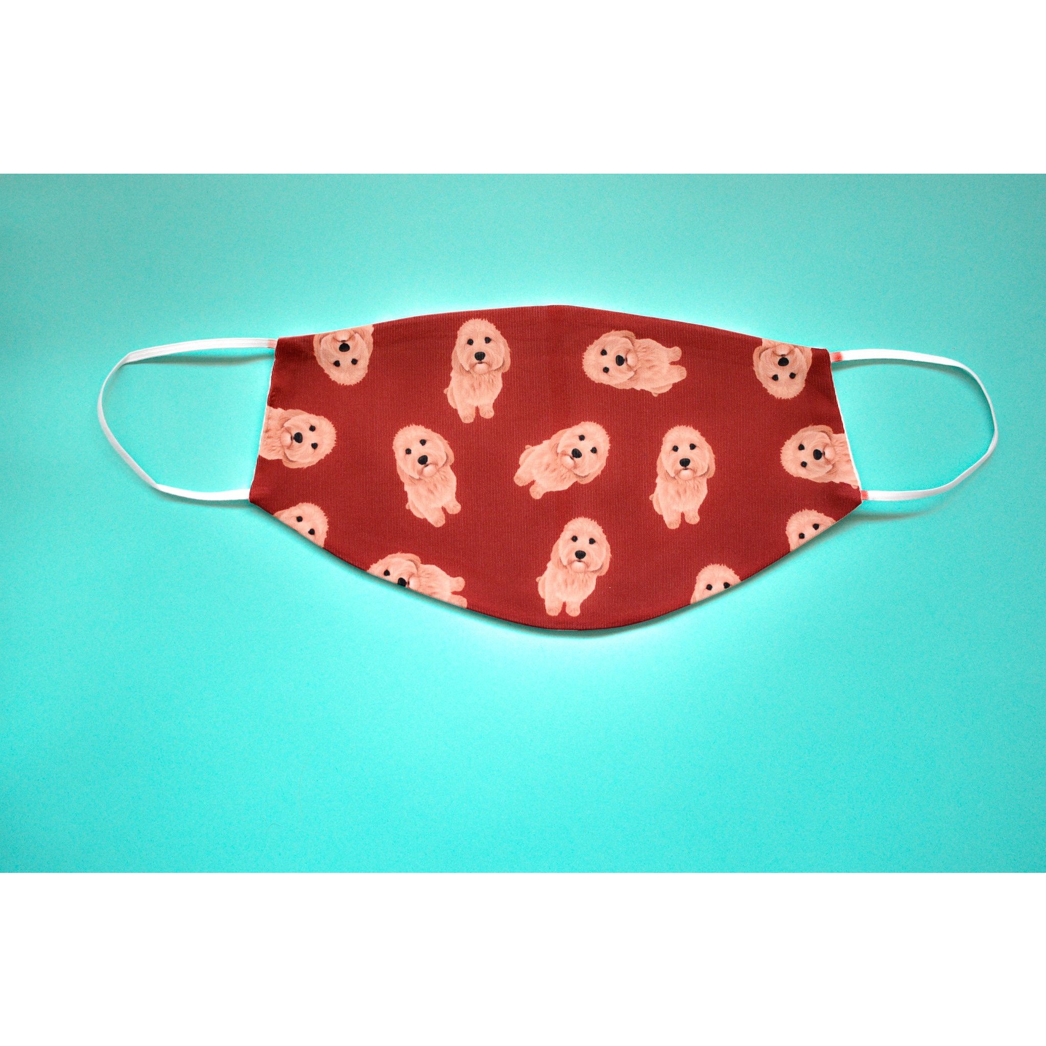 A stylish Cavapoo face cover made from breathable polyester and organic cotton, featuring a comfortable ear saver and available in various sizes.