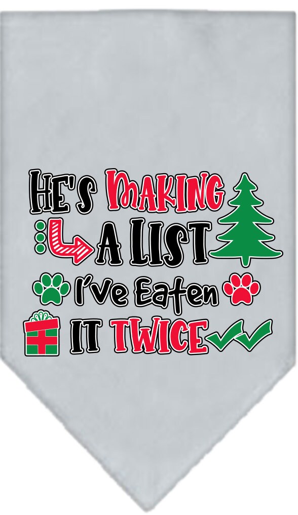A festive Christmas dog bandana featuring the phrase 'He's Making A List, I've Eaten It Twice', designed for tie-on use with no buckles.