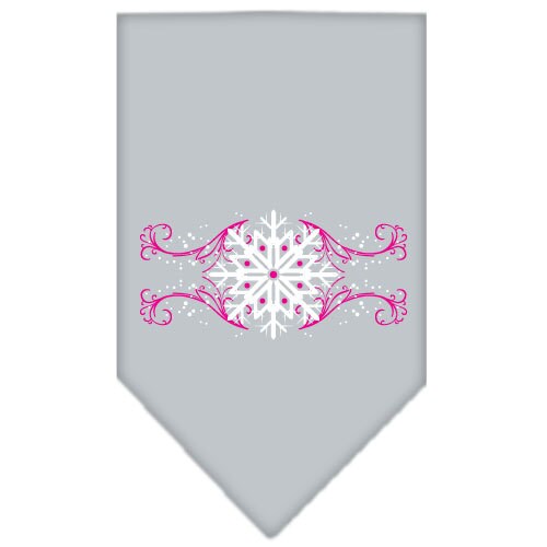 A pink dog bandana with snowflake swirls design, perfect for Christmas celebrations, tied around a dog's neck.