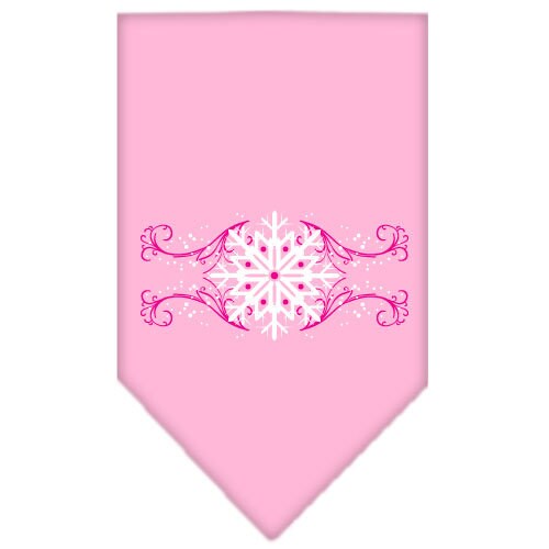 A pink dog bandana with snowflake swirls design, perfect for Christmas celebrations, tied around a dog's neck.