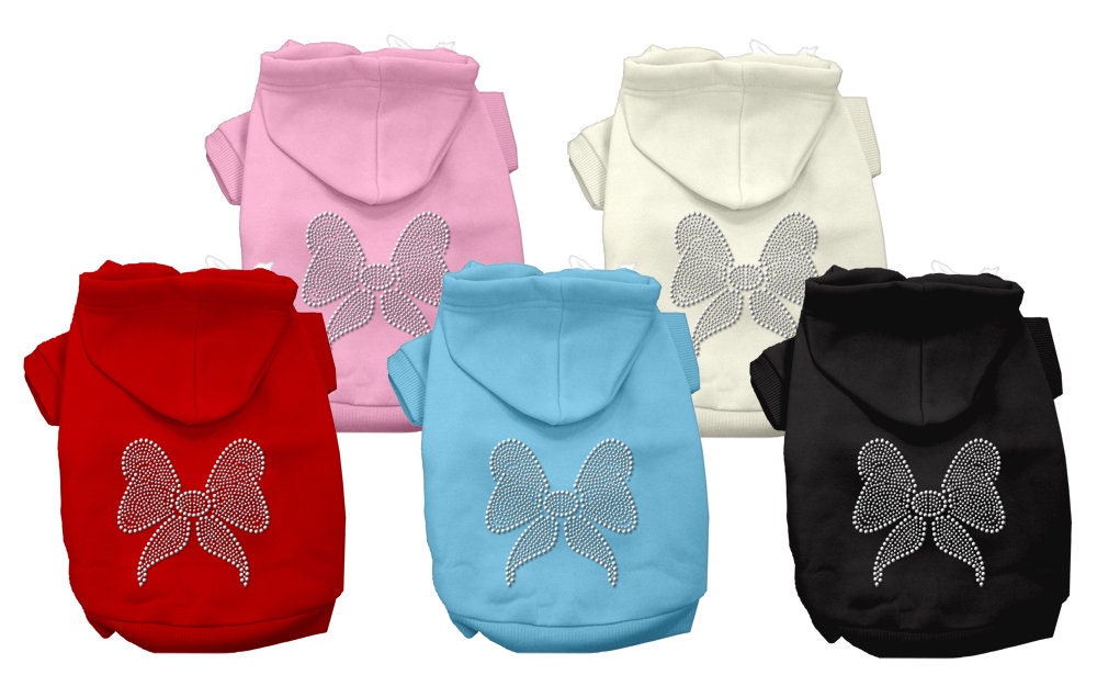 A festive Christmas hoodie for pets featuring a rhinestone bow, designed for dogs and cats, showcasing its soft fabric and stylish design.