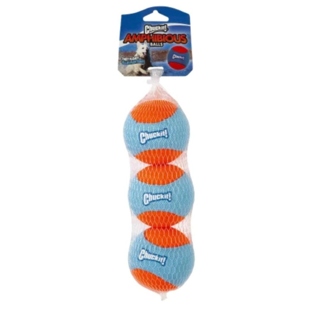 Three colorful Chuckit! Amphibious Balls floating on water, designed for dogs to fetch and play.