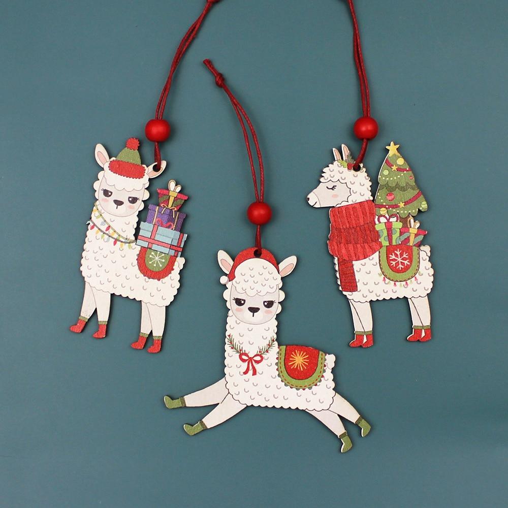 A set of three painted wooden alpaca Christmas ornaments, featuring vibrant colors and red hanging strings, perfect for holiday decorations.