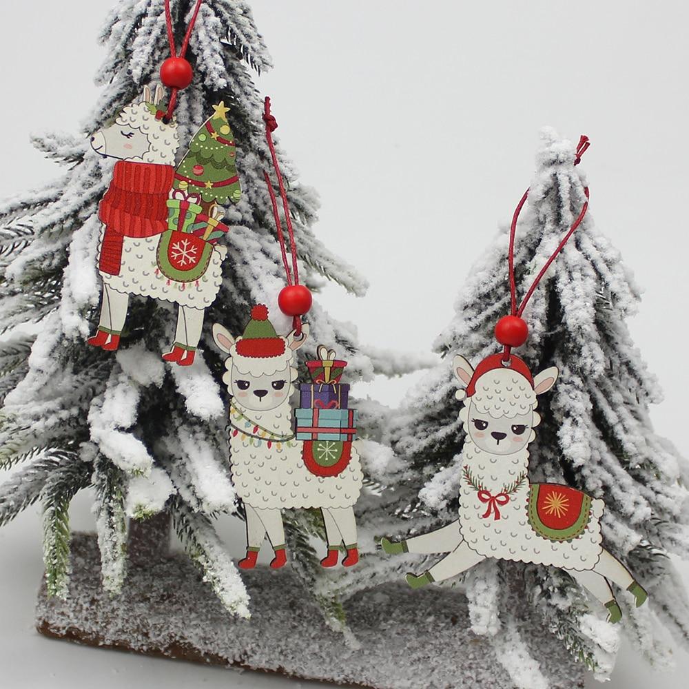 A set of three painted wooden alpaca Christmas ornaments, featuring vibrant colors and red hanging strings, perfect for holiday decorations.