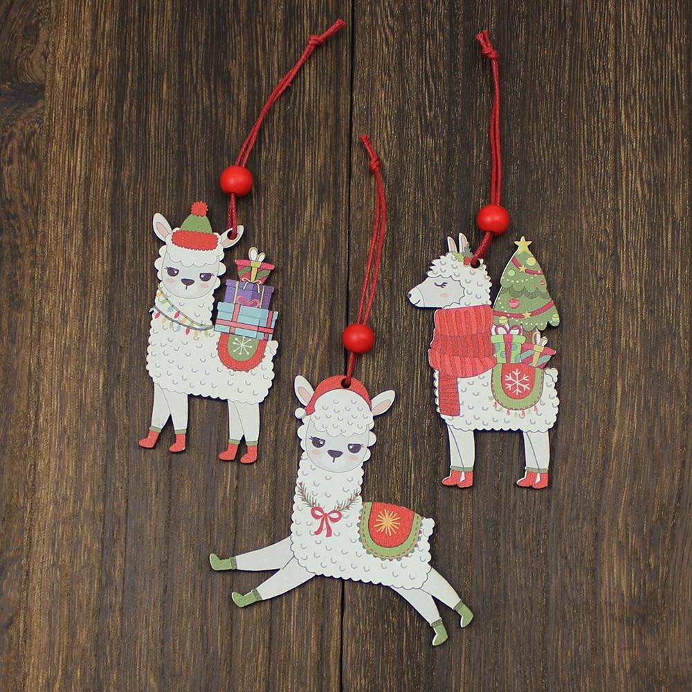 A set of three painted wooden alpaca Christmas ornaments, featuring vibrant colors and red hanging strings, perfect for holiday decorations.