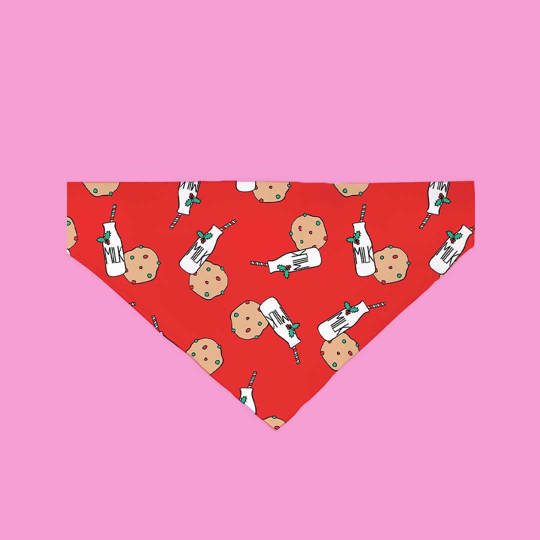 A vibrant red bandana featuring a cute cookies and milk pattern, designed for pets, showcasing its soft fabric and festive design.