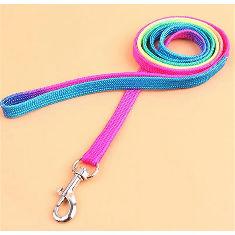A colorful adjustable pet leash displayed on a wooden surface, showcasing its vibrant colors and adjustable mechanism.
