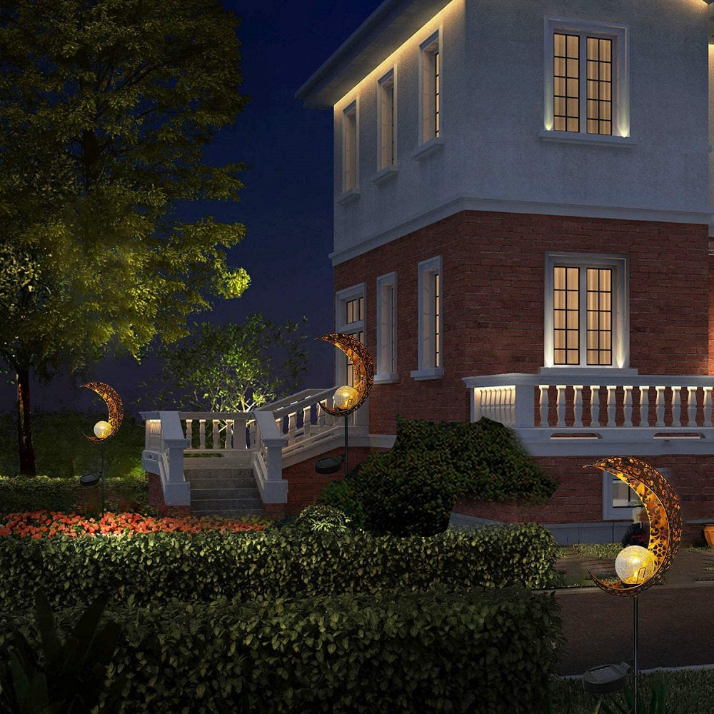 Crackle Glass Globe Metal Light illuminating a garden path, showcasing its beautiful design and warm white LED glow.