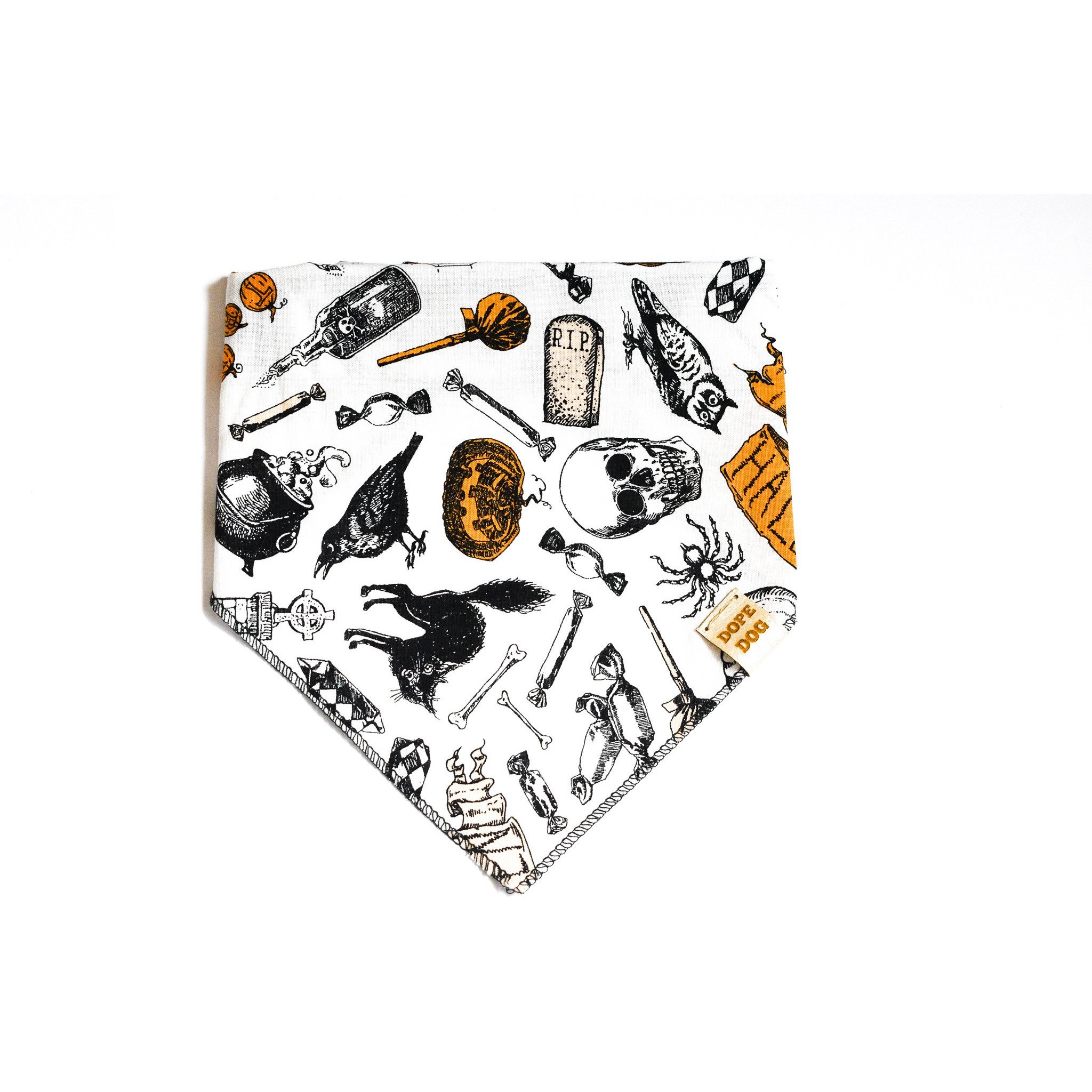 Creep it Real dog bandana featuring Halloween-themed cotton fabric and a vegan leather tag, perfect for stylish pets.