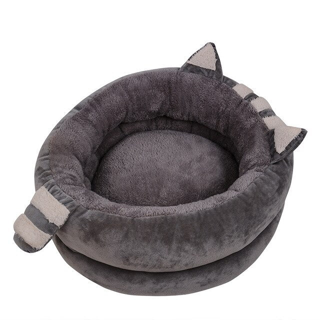A cozy Cute Cat Bed House made of soft fleece and PP cotton, designed for cats and dogs, featuring a warm and inviting sleeping space.