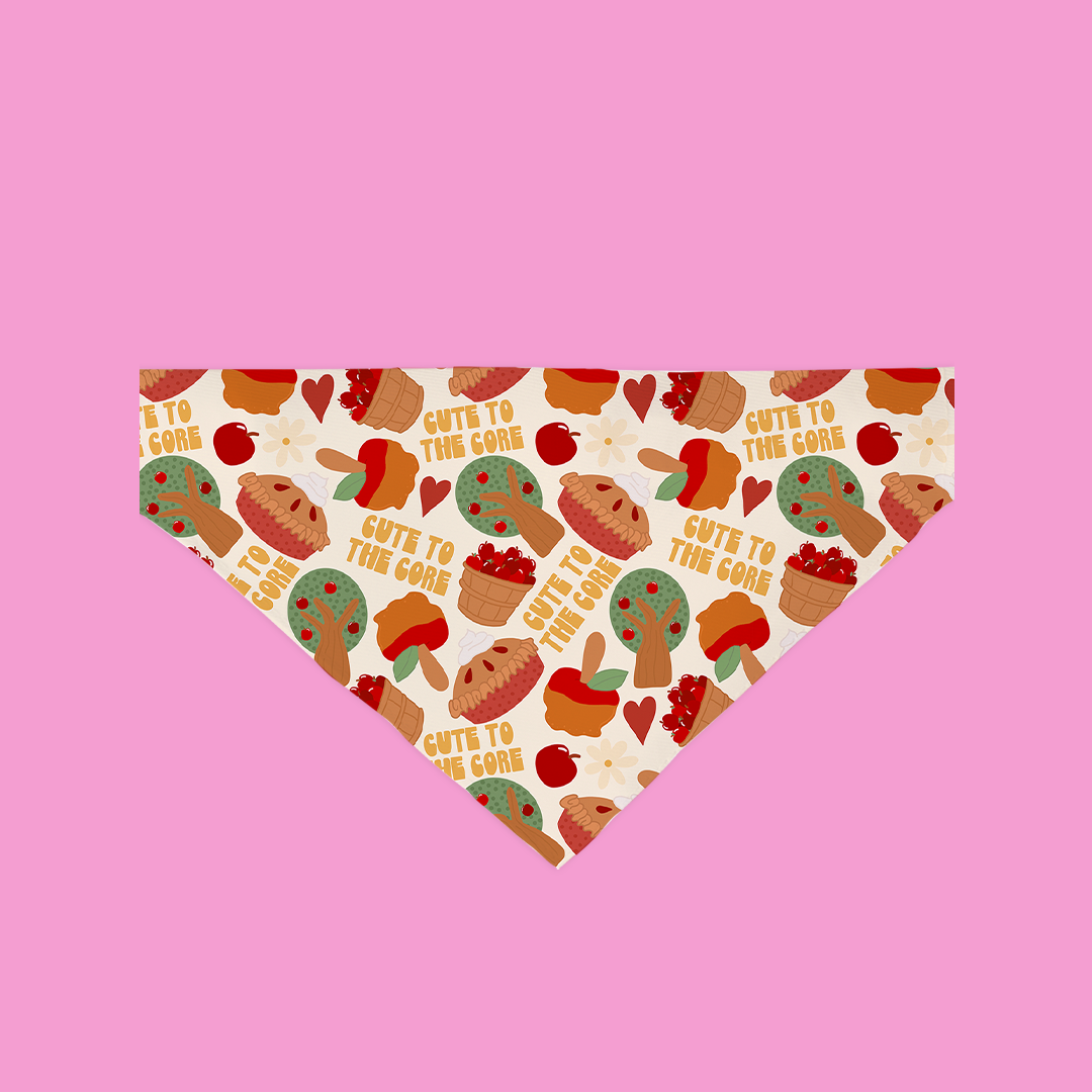 A cute dog wearing the Cute To The Core Bandana, showcasing its stylish design and secure fit over the collar.