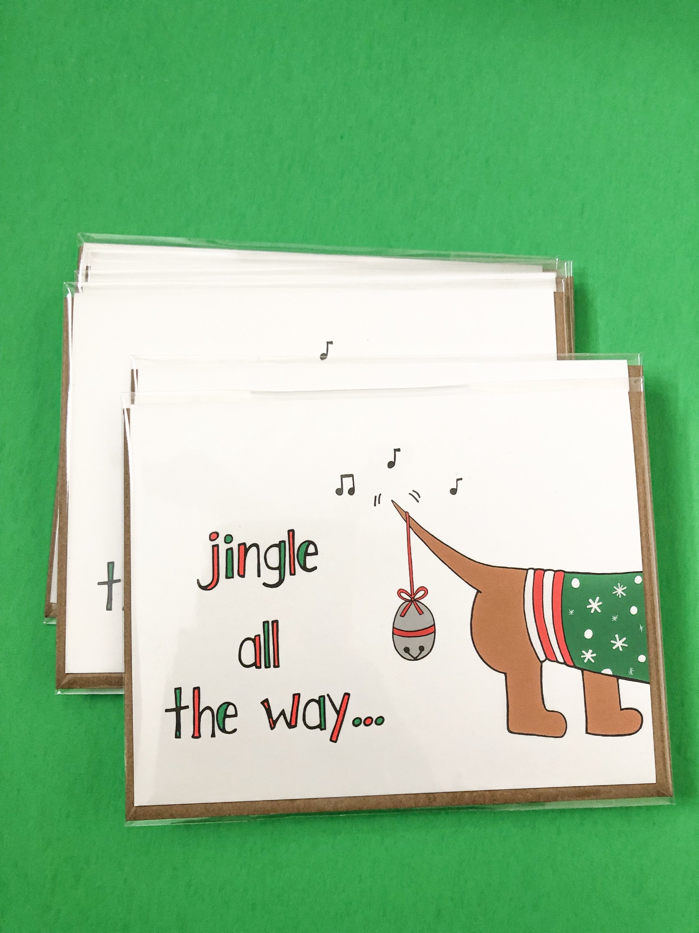 Dachshund Christmas Card featuring a dog in a Santa hat with festive text.