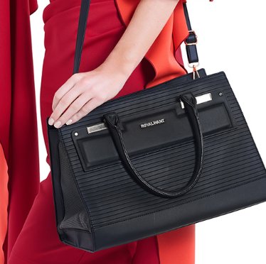 Designer black vegan-leather pet carrier for small dogs and cats, featuring mesh windows and a removable quilted lining.