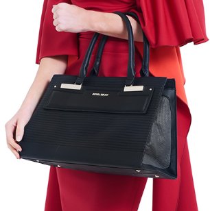 Designer black vegan-leather pet carrier for small dogs and cats, featuring mesh windows and a removable quilted lining.