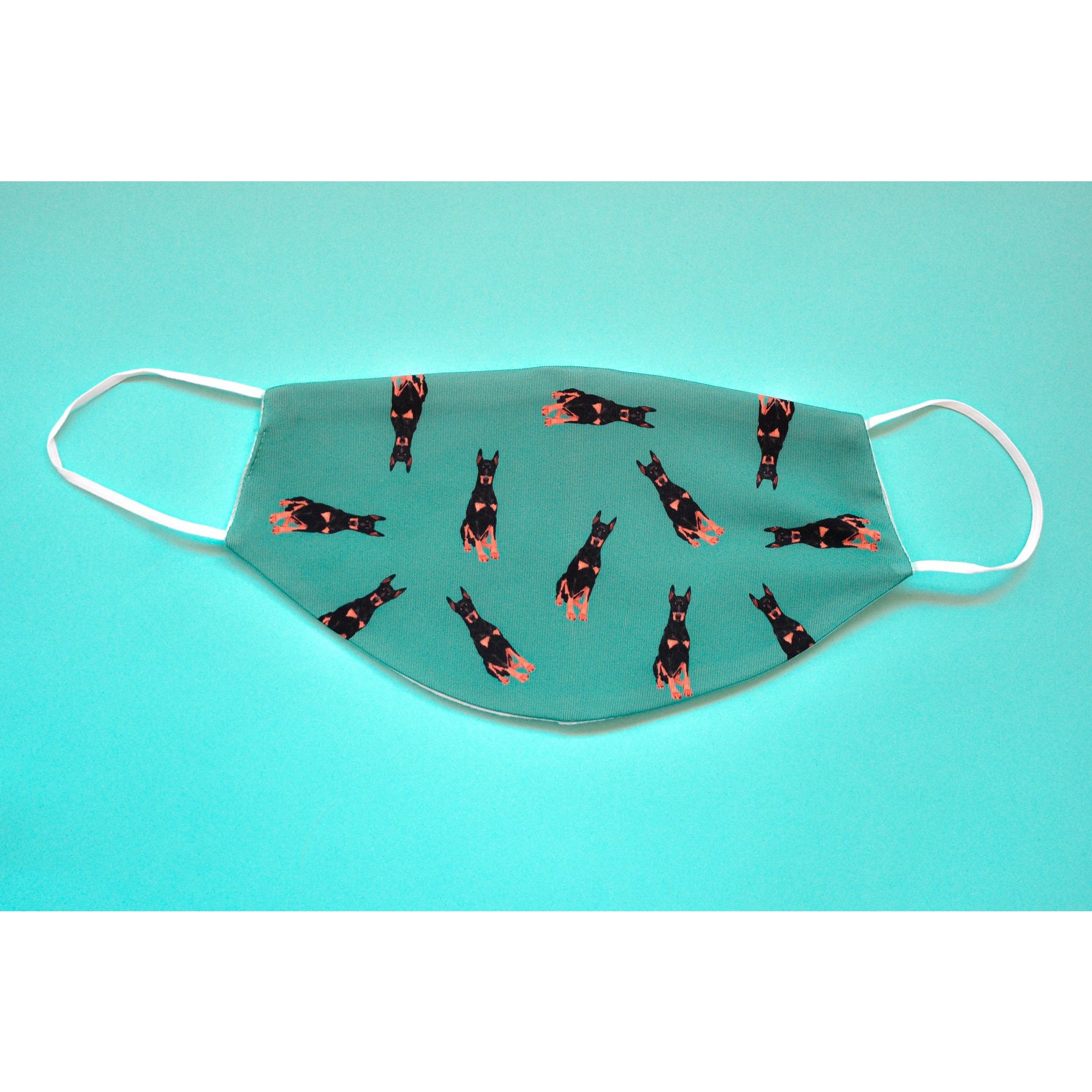 A stylish Doberman face cover made from breathable polyester and organic cotton, featuring a metal nose clip and ear saver.