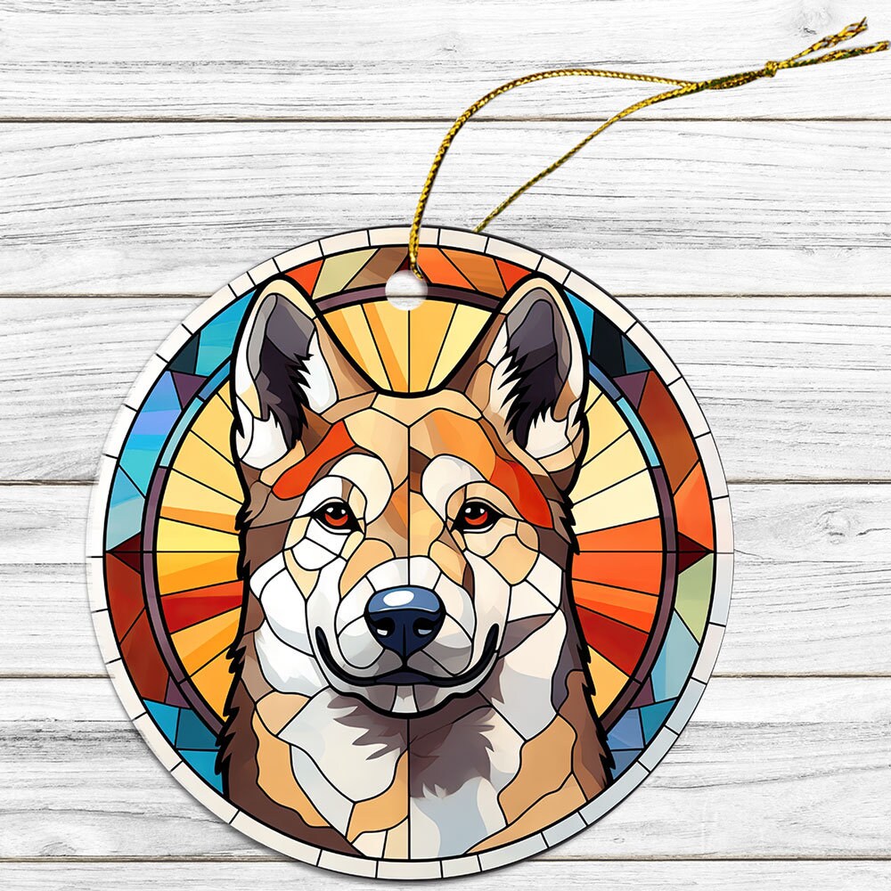 Stained glass style Christmas ornament featuring an Akita dog breed design, with a golden string for hanging.