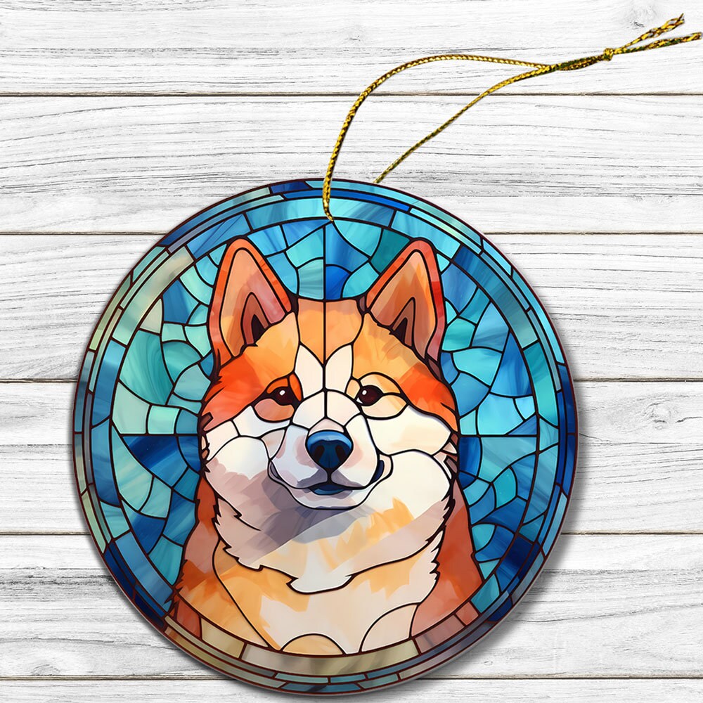 Stained glass style Christmas ornament featuring an Akita dog breed design, with a golden string for hanging.