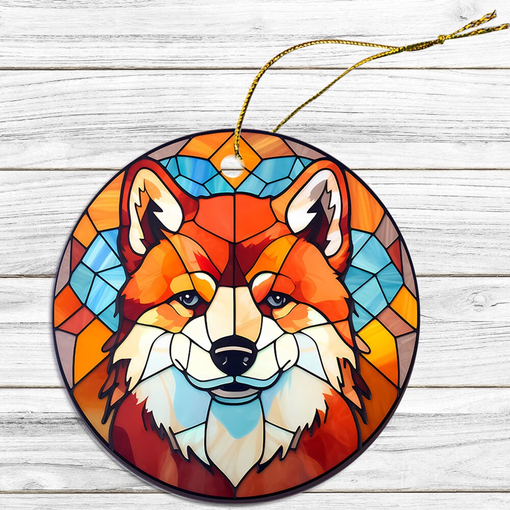 Stained glass style Christmas ornament featuring an Akita dog breed design, with a golden string for hanging.
