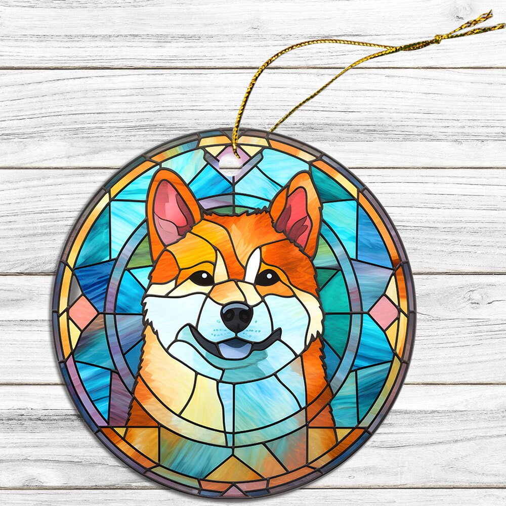 Stained glass style Christmas ornament featuring an Akita dog breed design, with a golden string for hanging.