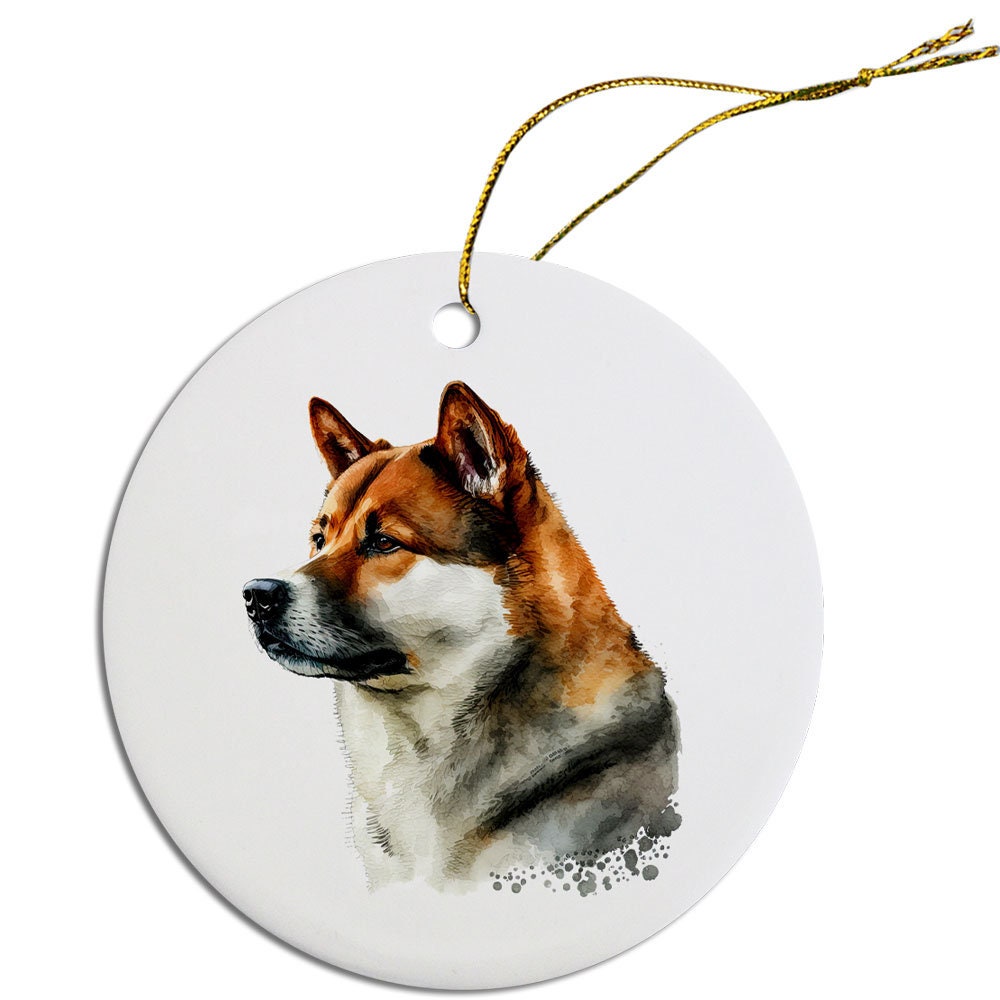 Ceramic round Christmas ornament featuring an Akita dog design with a golden string for hanging.